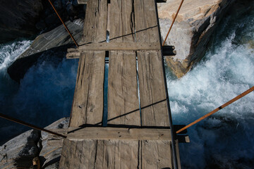 Wooden planks of suspension bridge over Nilgiri River, Annapurnas, Nepal