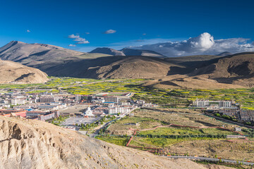 Canola blossoming fields and the sunset sky around Tibetan village in Sakya