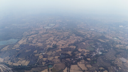 aerial view farmland landscape, rural countryside fields, scenic agriculture aerial shot, patchwork farm fields from above, village surrounded by fields, misty farmland horizon stock photo.