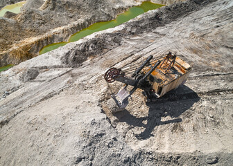 Rusty Shovel mining excavator digs chalk with bucket in mining pit