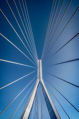 Fototapeta premium Modern Suspension Bridge: Engineering Marvel of Civil Infrastructure for Load Distribution and Environmental Stress Resistance