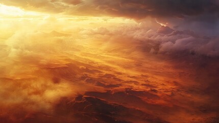 Fototapeta premium A breathtaking aerial view of a dramatic landscape illuminated by a golden sunset.