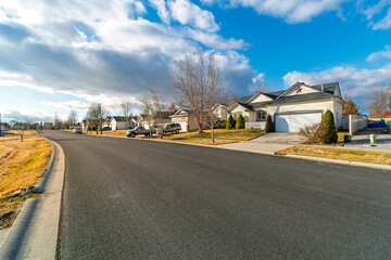A typical suburban street of homes at early winter in the town of Coeur d'Alene, Idaho, in the...