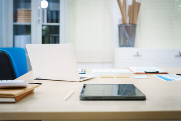 An office desk with a laptop, graphs, and documents neatly arranged. The workspace reflects a professional environment, ideal for tasks involving data analysis, reporting, and strategic planning