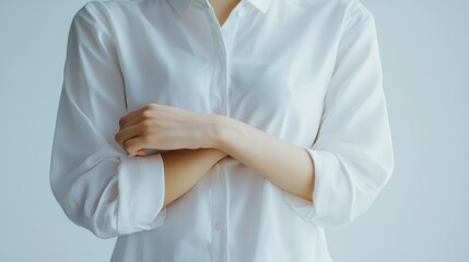 Woman in white shirt posing with crossed arms