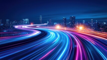 A vibrant cityscape at night with light trails from moving vehicles.