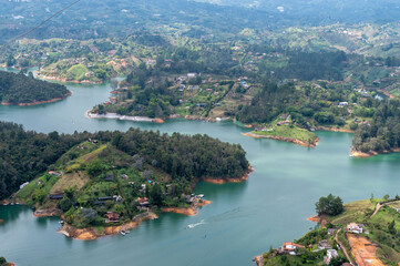 Serene landscape of tranquil waters nestled amongst lush green hills and charming villages.