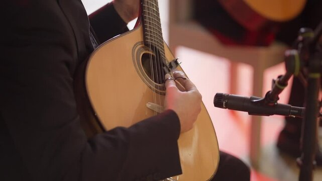 Musician playing Portuguese guitar with microphone setup for live performance