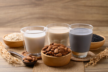 Alternative milk made from plant on wooden background, non dairy, Vegan food