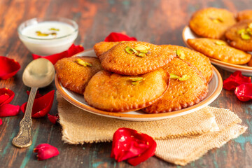 Malpua is a traditional Indian sweet made of flour, sugar, and coconut, deep-fried into crispy pancakes, often served with cardamom syrup or milk.