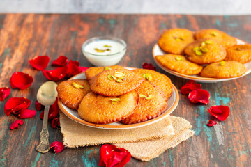Malpua is a traditional Indian sweet made of flour, sugar, and coconut, deep-fried into crispy pancakes, often served with cardamom syrup or milk.