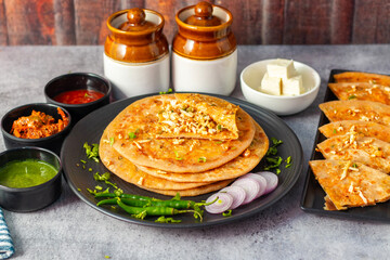 Paneer ka paratha is a delicious Indian flatbread stuffed with spiced paneer, served hot with chutney, curd, or pickle.