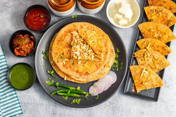Paneer ka paratha is a delicious Indian flatbread stuffed with spiced paneer, served hot with...