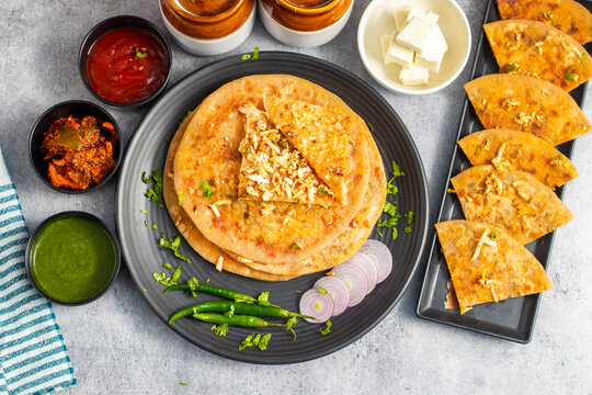 Paneer ka paratha is a delicious Indian flatbread stuffed with spiced paneer, served hot with chutney, curd, or pickle.