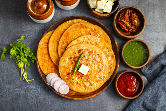 Paneer ka paratha is a delicious Indian flatbread stuffed with spiced paneer, served hot with chutney, curd, or pickle.