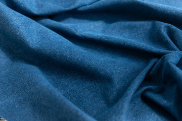 Abstract texture of natural blue color denim fabric.