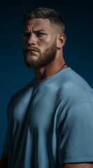Fototapeta premium Muscular Man in Blue T Shirt Portrait Studio Shot Strong Confident Serious