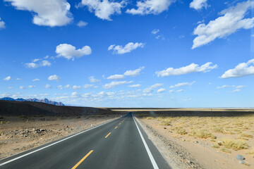 Naklejka premium Desert road sand dunes in Xinjiang, China