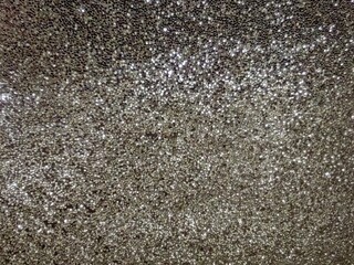 Sparkling gray crystals, lights in focus and out of focus. Wallpaper, background. 