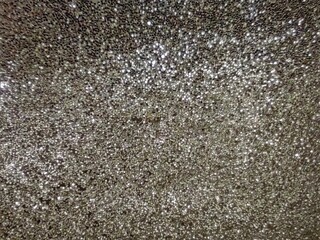 Sparkling gray crystals, lights in focus and out of focus. Wallpaper, background. 