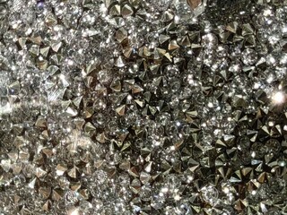 Sparkling gray crystals, lights in focus and out of focus. Wallpaper, background. 