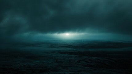 A moody seascape under dark clouds with a faint light breaking through.