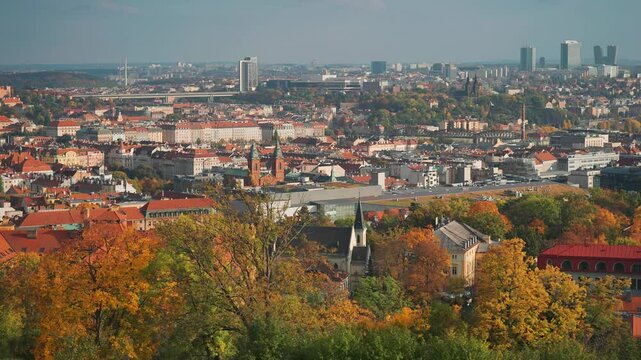 A panoramic view of Prague featuring vibrant autumn foliage, historic spires of Vysehrad, and modern high-rises at Pankrac.