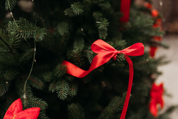 Beautiful stylish Christmas tree with festive red bows