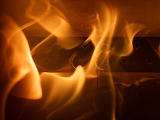 Flames lapping around the rear vent of a log burning stove