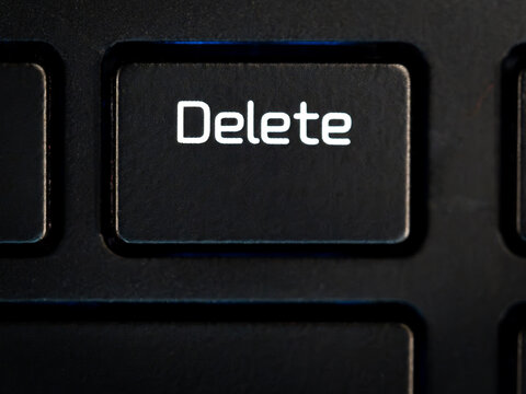 A close-up of a Delete key on a laptop keyboard