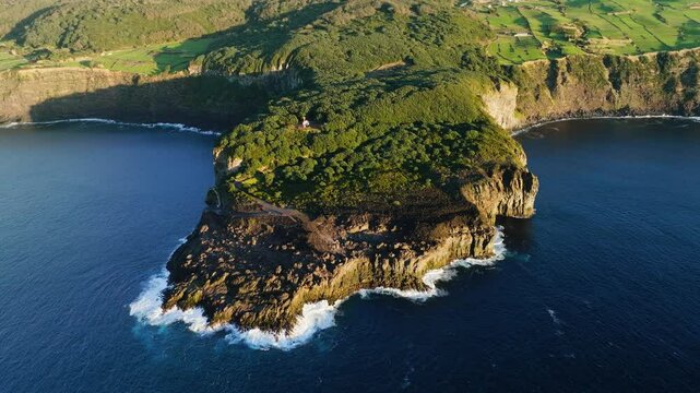 Aerial arc view of Farol da Serreta and Queimado viewpoint on Terceira headland