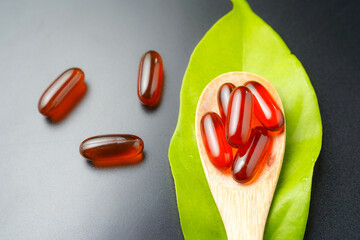 wooden spoon with soft gels, Fish oil capsules, omega 3, omega 9, vitamin D, vitamin E
