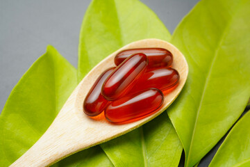 wooden spoon with soft gels, Fish oil capsules, omega 3, omega 9, vitamin D, vitamin E