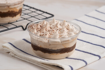 Tiramisu cake decorated with cocoa powder. Close up food. Traditional italian dessert. Perfect for recipe, article, catalogue, or any commercial purposes. with copy space.