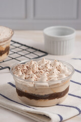 Tiramisu cake decorated with cocoa powder. Close up food. Traditional italian dessert. Perfect for recipe, article, catalogue, or any commercial purposes. with copy space.
