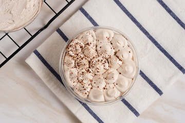 Tiramisu cake decorated with cocoa powder. Close up food. Traditional italian dessert. Perfect for recipe, article, catalogue, or any commercial purposes. with copy space.