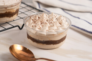 Tiramisu cake decorated with cocoa powder. Close up food. Traditional italian dessert. Perfect for recipe, article, catalogue, or any commercial purposes. with copy space.