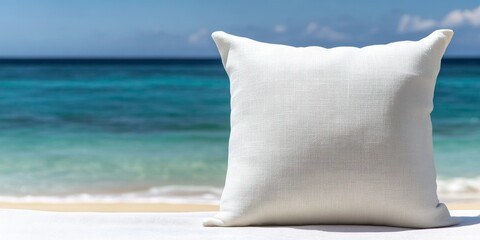 A white pillow contrasting against the backdrop of a blue sea in a beach setting creates a serene and visual experience of coastal tranquility.