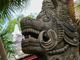 Stone carving of a dragon with open mouth