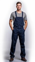 Fototapeta premium Man in navy overalls with gray t-shirt on white background. For repair services, technical maintenance, manufacturing facilities, assembly works, warehouse operations.