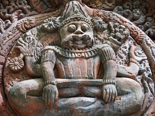 Statue of a man sitting on a rock