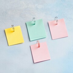 Colorful sticky notes in pastel shades arranged creatively on a soft blue background.