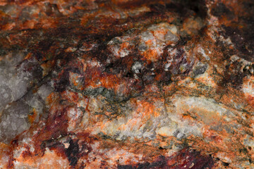 Multicolor grunge background with abstract colors of red, bright blue, white and ocher, granite stone texture. Various color elements of the picture.Stone, granite texture.Weathered background.