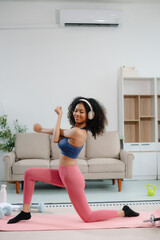 African Woman Doing Yoga and Watching Online Tutorials on Laptop, Training