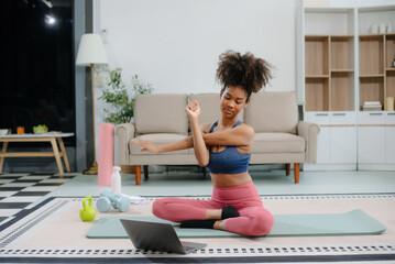 African Woman Doing Yoga and Watching Online Tutorials on Laptop, Training
