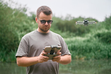 Outdoor drone operation by man with remote