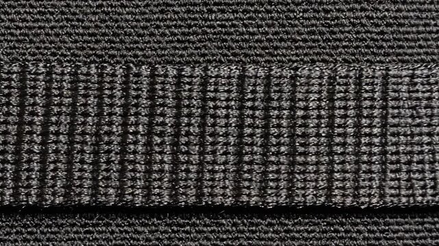 Textured black fabric with distinct ribbed pattern suitable for various crafting and design applications