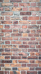 Vertical Brick Wall - Rustic Red Bricks with Weathered Texture and Cement Mortar, Perfect for Architectural Backgrounds