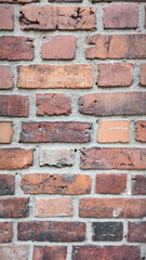 Close-Up Vertical Brick Wall - Rustic Red Bricks with Weathered Texture and Cement Mortar, Perfect for Architectural Backgrounds