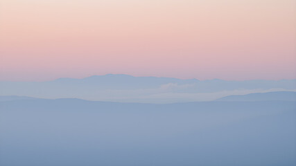 Fototapeta premium Fog in the mountains at sunset. Landscape of the mountains.